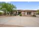 Inviting single-story home featuring a stone facade and a well-maintained front yard at 4684 E Coachwhip Rd, Cave Creek, AZ 85331