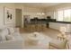 Open-concept kitchen with white cabinets, an island with seating, and stainless steel appliances at 4684 E Coachwhip Rd, Cave Creek, AZ 85331