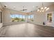 Inviting living room featuring large windows with views, modern lighting, and access to outdoor spaces at 4684 E Coachwhip Rd, Cave Creek, AZ 85331