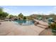 Inviting backyard pool features a rock waterfall and lounging area with mountain views at 4684 E Coachwhip Rd, Cave Creek, AZ 85331