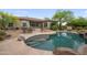 Backyard view of pool and home featuring an outdoor dining area and desert landscaping at 4684 E Coachwhip Rd, Cave Creek, AZ 85331