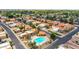 Aerial view of residential community with a shared pool, cabana, and mature trees at 5509 E Desert Hills Dr, Scottsdale, AZ 85254