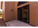 Covered patio area with desert landscaping and a view of the stucco exterior at 5509 E Desert Hills Dr, Scottsdale, AZ 85254