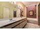 Bathroom with a double sink vanity, large mirror, and separate soaking tub and shower at 5509 E Desert Hills Dr, Scottsdale, AZ 85254