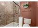 Small bathroom with neutral shower stall, updated toilet, and decorative accents at 5509 E Desert Hills Dr, Scottsdale, AZ 85254