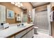 Bathroom featuring a vanity with a white sink and shower stall with sliding glass door at 5509 E Desert Hills Dr, Scottsdale, AZ 85254