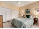 Comfortable bedroom with soft decor, closet, and updated tile flooring at 5509 E Desert Hills Dr, Scottsdale, AZ 85254