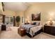 Spacious bedroom features a vaulted ceiling, neutral decor, and sliding door to patio at 5509 E Desert Hills Dr, Scottsdale, AZ 85254