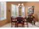 Bright and airy dining area featuring ample natural light from a large bay window at 5509 E Desert Hills Dr, Scottsdale, AZ 85254