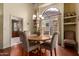 Charming dining room area featuring a round table, four chairs, and natural light from the window at 5509 E Desert Hills Dr, Scottsdale, AZ 85254