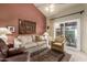 Cozy living room with a vaulted ceiling, comfortable seating, and sliding glass doors at 5509 E Desert Hills Dr, Scottsdale, AZ 85254