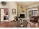 Bright living room features wood floors, a fireplace, and a sliding glass door to the outdoor space at 5509 E Desert Hills Dr, Scottsdale, AZ 85254