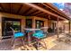 Inviting covered patio with table and chairs, perfect for outdoor relaxation and entertaining at 5509 E Desert Hills Dr, Scottsdale, AZ 85254