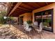 Charming covered patio area with seating perfect for outdoor dining and relaxation at 5509 E Desert Hills Dr, Scottsdale, AZ 85254
