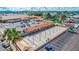 Aerial view of community featuring a shuffleboard area, clubhouse, parking and desert landscaping at 650 N Hawes Rd # 4128, Mesa, AZ 85207
