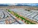 Breathtaking aerial shot of a sprawling community adjacent to a lush golf course set against a mountain backdrop at 650 N Hawes Rd # 4128, Mesa, AZ 85207
