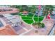 Aerial view of community courtyard with manicured lawn, gazebo, walkways, and covered seating areas at 650 N Hawes Rd # 4128, Mesa, AZ 85207