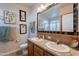 Bathroom with a double sink vanity, a large mirror, and beautiful decorations at 650 N Hawes Rd # 4128, Mesa, AZ 85207