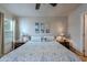 This well-lit bedroom features neutral walls, ceiling fan and bedside lamps at 650 N Hawes Rd # 4128, Mesa, AZ 85207
