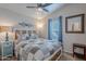Bedroom with a ceiling fan, comfy bed, and natural lighting at 650 N Hawes Rd # 4128, Mesa, AZ 85207
