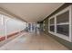 Open covered patio with epoxy flooring, bright lighting, and easy access to parking at 650 N Hawes Rd # 4128, Mesa, AZ 85207