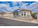 Charming home featuring a cozy front porch with a blue umbrella, creating a welcoming outdoor living space at 650 N Hawes Rd # 4128, Mesa, AZ 85207