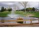 Scenic golf course view with a pond, fountain, and golfers enjoying the course at 650 N Hawes Rd # 4128, Mesa, AZ 85207