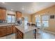 Spacious kitchen with a central island, ample cabinet space, and an adjacent dining area filled with natural light at 650 N Hawes Rd # 4128, Mesa, AZ 85207
