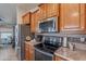 Close-up view of the kitchen featuring stainless steel appliances, modern countertops, and plenty of storage space at 650 N Hawes Rd # 4128, Mesa, AZ 85207