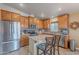 Bright kitchen featuring an island with bar seating, stainless steel appliances, and ample cabinet space at 650 N Hawes Rd # 4128, Mesa, AZ 85207