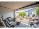 Inviting covered patio with comfortable seating, a fire pit, and views of a landscaped yard at 650 N Hawes Rd # 4128, Mesa, AZ 85207