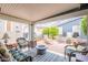 Inviting covered patio with comfortable seating, a fire pit, and views of a landscaped yard at 650 N Hawes Rd # 4128, Mesa, AZ 85207
