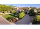 Impressive aerial view featuring lush landscaping, a paver driveway, and mature manicured trees at 6997 E Paradise Ranch Rd, Paradise Valley, AZ 85253