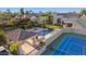 Exceptional aerial view of tennis courts, lush yard, glistening pool, and covered outdoor space at 6997 E Paradise Ranch Rd, Paradise Valley, AZ 85253