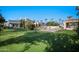 Expansive backyard featuring a lush lawn, sparkling pool, mature landscaping, and covered outdoor living spaces at 6997 E Paradise Ranch Rd, Paradise Valley, AZ 85253