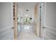 Luxurious bathroom entry featuring marble floors, cabinetry, and a chandelier at 6997 E Paradise Ranch Rd, Paradise Valley, AZ 85253