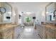 Elegant bathroom with dual vanities, a soaking tub, and a chandelier at 6997 E Paradise Ranch Rd, Paradise Valley, AZ 85253