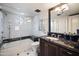 Modern bathroom with marble walk-in shower, dark vanity, and stylish fixtures at 6997 E Paradise Ranch Rd, Paradise Valley, AZ 85253