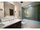 Bathroom features a large mirror, marble countertops, a glass-enclosed shower, and a heated towel rack at 6997 E Paradise Ranch Rd, Paradise Valley, AZ 85253