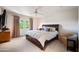 Spacious bedroom with French doors, a comfortable bed, and a ceiling fan at 6997 E Paradise Ranch Rd, Paradise Valley, AZ 85253