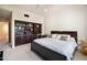 Bedroom features a built-in bookshelf, queen bed, and light carpet at 6997 E Paradise Ranch Rd, Paradise Valley, AZ 85253