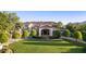 Elegant home showcasing a manicured lawn, tasteful landscaping, and a charming Mediterranean-style facade at 6997 E Paradise Ranch Rd, Paradise Valley, AZ 85253