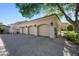 Spacious three-car garage featuring recessed lighting, and a durable paver driveway at 6997 E Paradise Ranch Rd, Paradise Valley, AZ 85253