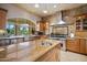 Gourmet kitchen with granite counters, stainless steel appliances and large island with sink at 6997 E Paradise Ranch Rd, Paradise Valley, AZ 85253