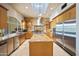 Open kitchen features an island, stone countertops, stainless steel appliances, and natural light at 6997 E Paradise Ranch Rd, Paradise Valley, AZ 85253