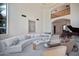 Spacious living area with high ceilings, modern furniture, and large windows at 6997 E Paradise Ranch Rd, Paradise Valley, AZ 85253