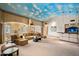 Open living room features a star and sky painted ceiling, custom cabinets, comfortable seating, and wet bar at 6997 E Paradise Ranch Rd, Paradise Valley, AZ 85253