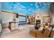 Spacious living room featuring a star and sky painted ceiling, custom cabinets, fireplace, and comfortable seating at 6997 E Paradise Ranch Rd, Paradise Valley, AZ 85253