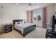 Bright main bedroom with French doors leading to the exterior, a ceiling fan, and neutral carpeting at 6997 E Paradise Ranch Rd, Paradise Valley, AZ 85253