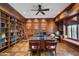 Executive office featuring wood paneling, built-in bookshelves, and a parquet floor at 6997 E Paradise Ranch Rd, Paradise Valley, AZ 85253